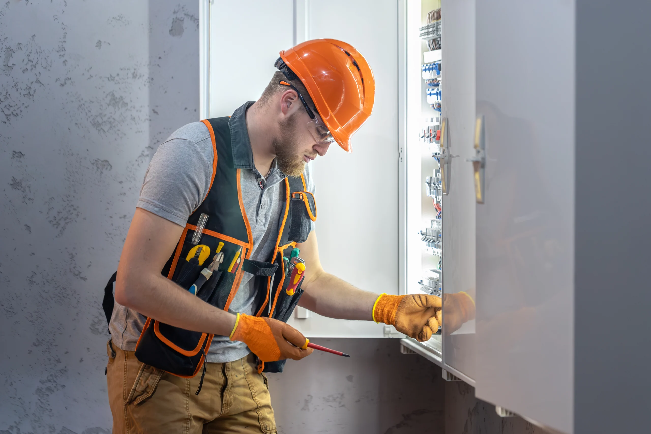 male electrician working switchboard male electrician overalls working with electricity scaled Home